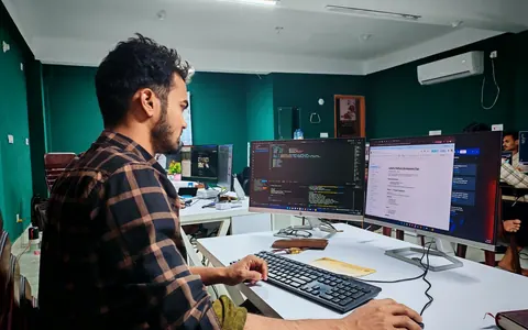 A developer working on software in a modern office — illustrative stock photo, not Bookhelp vendors or customers